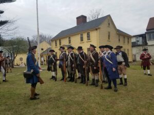 Minutemen reenactors standing in front of Jason Russell House
